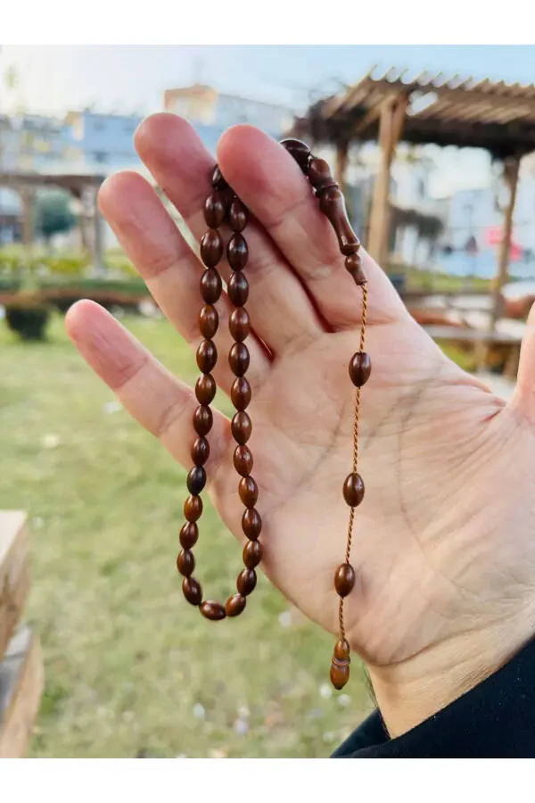 A prayer bead made of kukas, adorned with barley grains. - 2