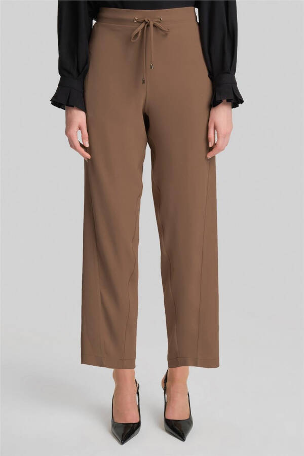 Asymmetrical belted pants, code 24Y2609, almond color. - 3