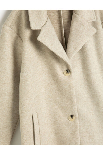 Long coat with button closure and pocket details. - 3