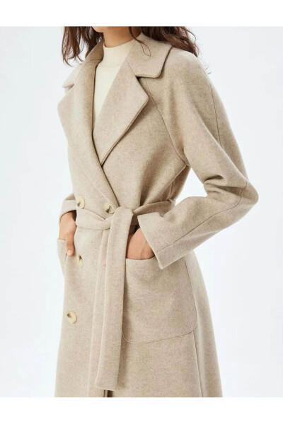 Long, double-breasted, pocket and belt detailed cashmere coat. - 32