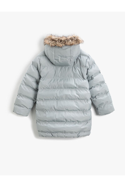 Long puffer jacket with a hood, zippered pockets, and faux fur details. - 5