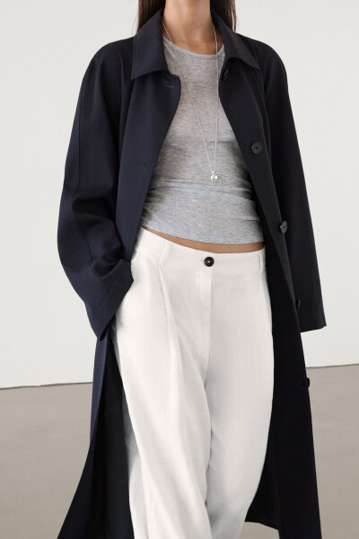 Navy trench coat with belt and pockets. - 2