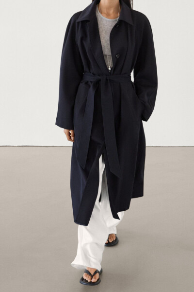 Navy trench coat with belt and pockets. - 4