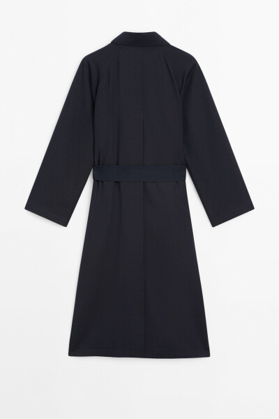 Navy trench coat with belt and pockets. - 7