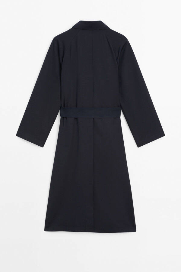 Navy trench coat with belt and pockets. - 7