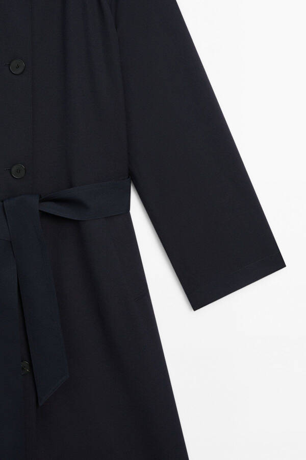 Navy trench coat with belt and pockets. - 8