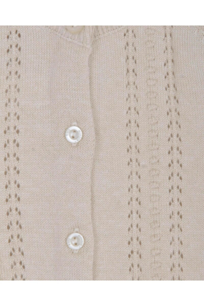 Short, beige knitted baby cardigan with lace and pom-poms. - MINORA (1)