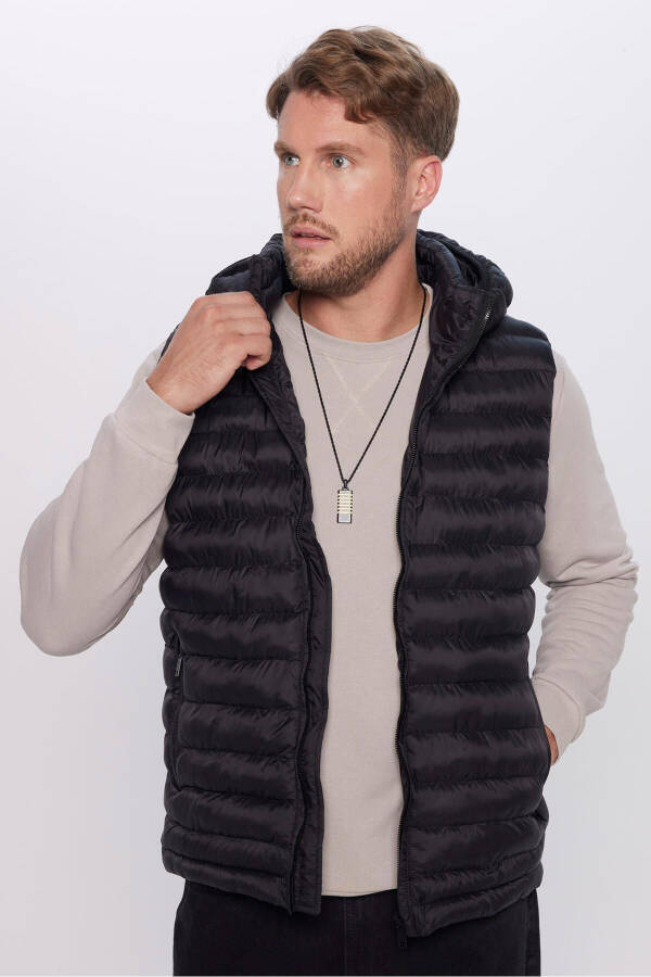 Slim fit, windproof, black puffer vest with detachable hood, pockets and lining. - 8