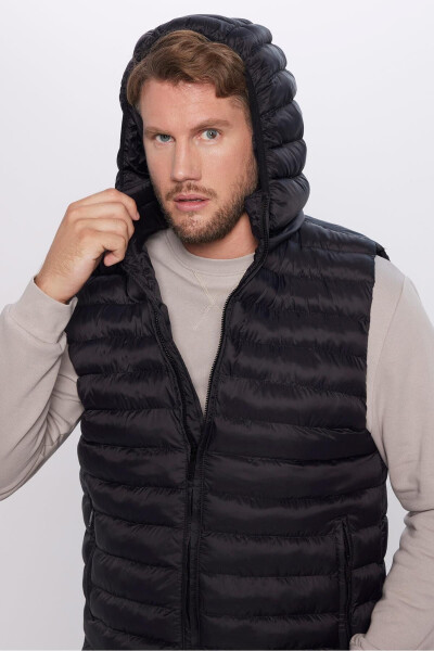 Slim fit, windproof, black puffer vest with detachable hood, pockets and lining. - 9