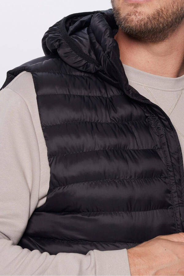 Slim fit, windproof, black puffer vest with detachable hood, pockets and lining. - 10