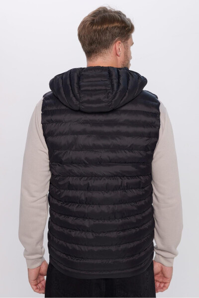 Slim fit, windproof, black puffer vest with detachable hood, pockets and lining. - 11