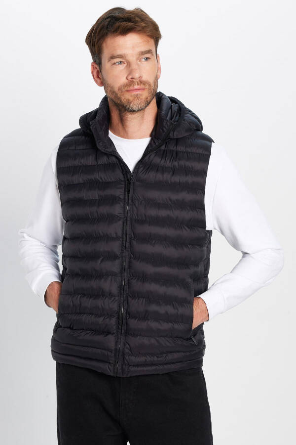 Slim fit, windproof, black puffer vest with detachable hood, pockets and lining. - 2