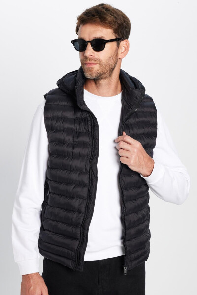 Slim fit, windproof, black puffer vest with detachable hood, pockets and lining. - 4