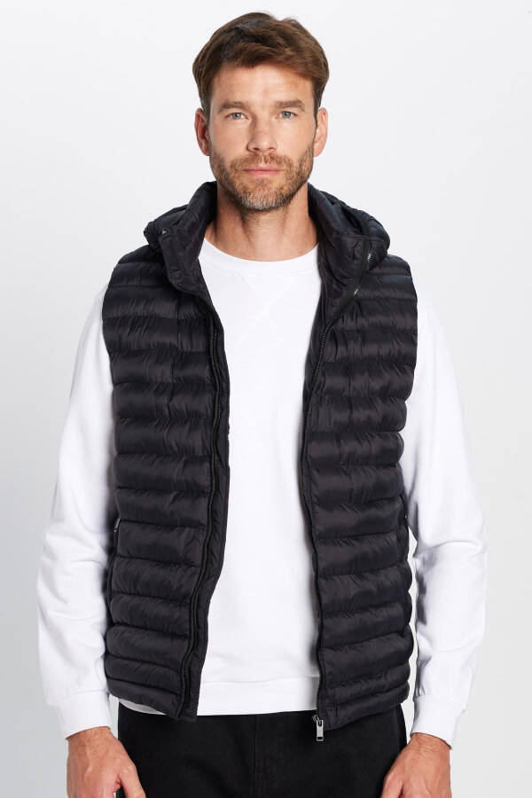 Slim fit, windproof, black puffer vest with detachable hood, pockets and lining. - 5