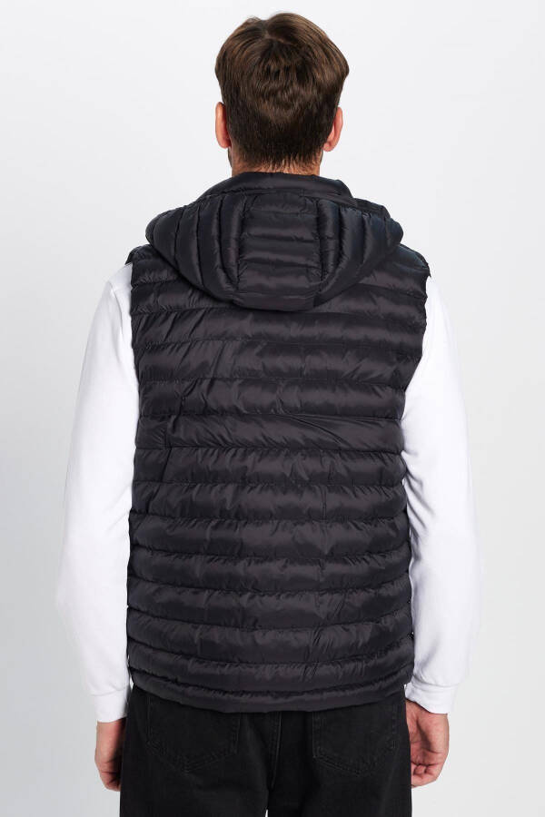 Slim fit, windproof, black puffer vest with detachable hood, pockets and lining. - 6