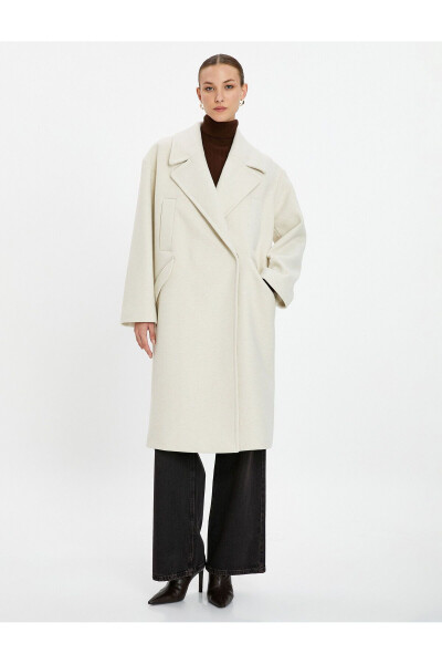 Wool coat with double-breasted closure and hidden pocket detail. - 9